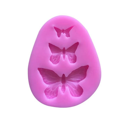 Pink silicone mold with butterfly shapes on a white background